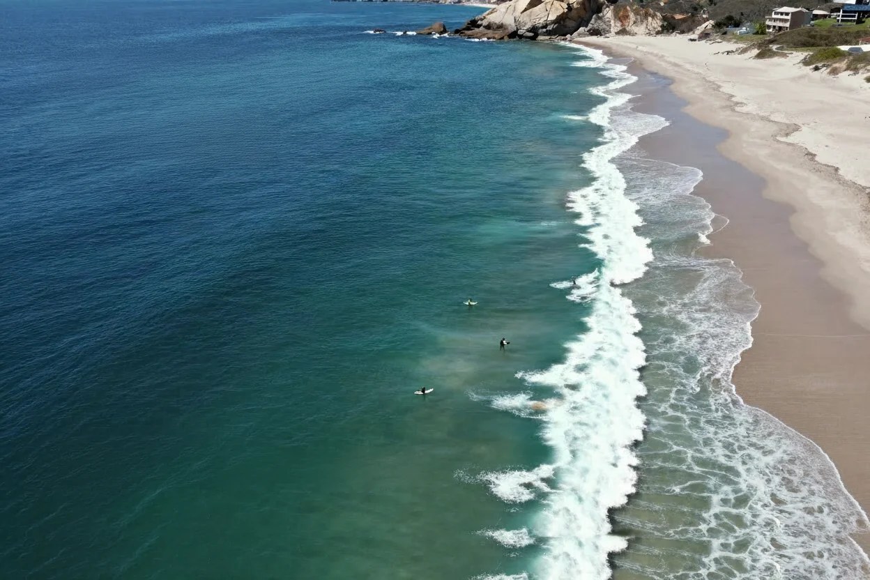 Aerial view of Pacific waves reaching the coast